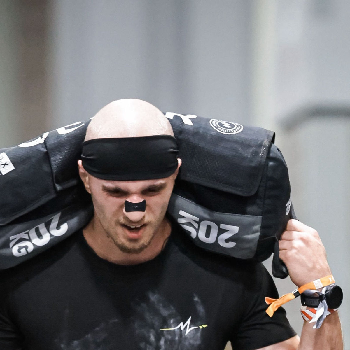 KOUXY Performance Headband worn during a sandbag lunge at HYROX Washington DC